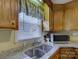 Kitchen corner sink with granite countertops and microwave at 22 Henry Ave, Belmont, NC 28012