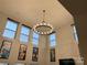 High-ceiling living room with a large chandelier and expansive windows at 4308 29Th Street Ne Dr, Hickory, NC 28601