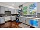 Modern kitchen with gray cabinets, blue appliances, and dark hardwood floors at 523 Carolina Blvd, Salisbury, NC 28146