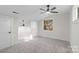 Bedroom with neutral carpeting, ceiling fan, and window with natural light at 7324 Pleasant Grove Rd, Charlotte, NC 28216