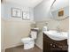 Updated bathroom with a modern vanity, a toilet, and a stylish mirror at 8002 Regent Park Ln, Charlotte, NC 28210