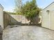 Backyard patio with tile flooring, wood fence, and a small tree at 8002 Regent Park Ln, Charlotte, NC 28210