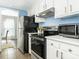 Updated kitchen with stainless steel appliances and a microwave at 8002 Regent Park Ln, Charlotte, NC 28210