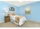 Light and airy bedroom with light blue walls, a twin-sized bed and natural light at 8002 Regent Park Ln, Charlotte, NC 28210