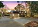 Two-story house with brick and brown siding, a large driveway, and mature trees at 841 12Th Nw Ave, Hickory, NC 28601