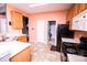 Kitchen with wood cabinets, black appliances, and tile floor at 8527 Carolina Lily Ln, Charlotte, NC 28262