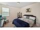 Bright bedroom with a queen-size bed and built-in shelving at 12614 Chantrey Way, Huntersville, NC 28078