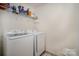 Laundry room with washer, dryer, and extra shelving at 12614 Chantrey Way, Huntersville, NC 28078