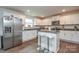 Modern kitchen with white cabinets, granite counters, and stainless steel appliances at 318 Kingsford Dr, Stanley, NC 28164