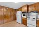 White appliances and wood cabinets in this kitchen at 4501 Taylorsville Hwy, Statesville, NC 28625