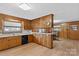 Kitchen with wood cabinets, laminate flooring, and a breakfast bar at 4501 Taylorsville Hwy, Statesville, NC 28625