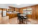 Kitchen with wood cabinets, a built-in shelving unit, and a dining area at 4501 Taylorsville Hwy, Statesville, NC 28625