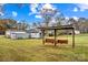 Serene backyard with double swing and outbuildings at 4501 Taylorsville Hwy, Statesville, NC 28625