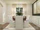 Bright dining room with a wood table, white chairs, and neutral decor at 160 Dogwood Grove Pl, Troutman, NC 28166