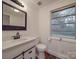 Updated bathroom with white vanity and dark wood floors at 41 Calhoun St, Great Falls, SC 29055