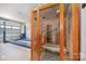 Relax in this private home sauna, complete with a glass door and comfortable bench at 643 Tennyson Dr, Charlotte, NC 28208