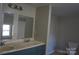 Updated bathroom with double vanity and modern fixtures at 7318 Old Mt Holly Rd, Charlotte, NC 28214