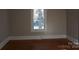 Simple bedroom with hardwood floors and a window at 7318 Old Mt Holly Rd, Charlotte, NC 28214