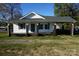 Charming one-story house with a covered porch and well-maintained lawn at 7318 Old Mt Holly Rd, Charlotte, NC 28214