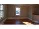 Bright living room featuring hardwood floors and large windows at 7318 Old Mt Holly Rd, Charlotte, NC 28214