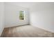 Well-lit bedroom with carpet and a window at 1062 Kinship Dr # 112, Lancaster, SC 29720