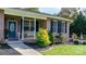 Brick house with front porch, blue door and landscaping at 1246 Hillsboro Ave, Hickory, NC 28602