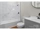 Clean bathroom with marble tile shower/tub combo, gray vanity, and a modern aesthetic at 335 Green St, Rock Hill, SC 29730