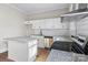 Modern kitchen featuring granite countertops, white cabinets, and stainless steel appliances at 335 Green St, Rock Hill, SC 29730