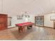 Basement recreation room with pool table and access to backyard at 376 Oak Tree Rd, Mooresville, NC 28117