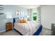 Well-lit bedroom with a blue bed frame and geometric decor at 3958 Ashton Nw Dr, Conover, NC 28613