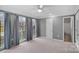 Bedroom with large windows, gray walls, carpet, and access to bathroom at 6200 Crestwick Ct, Charlotte, NC 28269