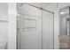 Shower with glass sliding door and built-in shelves at 6200 Crestwick Ct, Charlotte, NC 28269