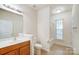 Clean bathroom with a tub, shower, toilet and wood vanity at 6831 Cinnamon Cir, Mint Hill, NC 28227