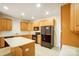 Modern kitchen with light wood cabinets, black appliances, and an island at 6831 Cinnamon Cir, Mint Hill, NC 28227