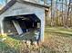 Detached garage with various items stored inside at 722 Tanglewood Dr, Salisbury, NC 28144