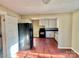 Simple kitchen with white cabinets, granite countertops, and dark wood floors at 722 Tanglewood Dr, Salisbury, NC 28144
