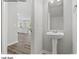 Convenient half bathroom with pedestal sink and view to living area at 204 Lake George Dr, Shelby, NC 28152