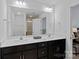 Clean bathroom with double vanity and dark brown cabinets at 208 Waterlynn Ridge Rd # B, Mooresville, NC 28117