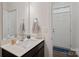 Clean and modern powder room with dark vanity and white sink at 208 Waterlynn Ridge Rd # B, Mooresville, NC 28117