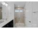 Bathroom with double vanity, shower, and neutral tile at 208 Waterlynn Ridge Rd # B, Mooresville, NC 28117