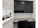 Built-in kitchen desk with granite countertop and black cabinets at 208 Waterlynn Ridge Rd # B, Mooresville, NC 28117