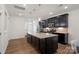 Modern kitchen with dark cabinetry, granite island, and stainless steel appliances at 208 Waterlynn Ridge Rd # B, Mooresville, NC 28117