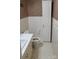 Clean bathroom with white tiled walls and a linen cabinet at 441 Holly Cir, Mount Holly, NC 28120