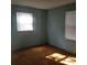 Well-lit bedroom with light teal walls and carpet flooring at 441 Holly Cir, Mount Holly, NC 28120