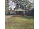 Brick ranch home with a covered porch and a spacious yard at 441 Holly Cir, Mount Holly, NC 28120
