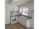 Efficient kitchen with white cabinets and vinyl flooring at 441 Holly Cir, Mount Holly, NC 28120