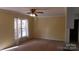 Bright living room featuring a large window and ceiling fan at 441 Holly Cir, Mount Holly, NC 28120