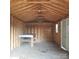 Interior of a shed with wood walls and a metal workbench at 441 Holly Cir, Mount Holly, NC 28120