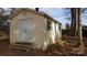 Tan colored storage shed with double doors and green shutters at 441 Holly Cir, Mount Holly, NC 28120
