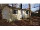 Tan colored storage shed with double doors and green shutters at 441 Holly Cir, Mount Holly, NC 28120